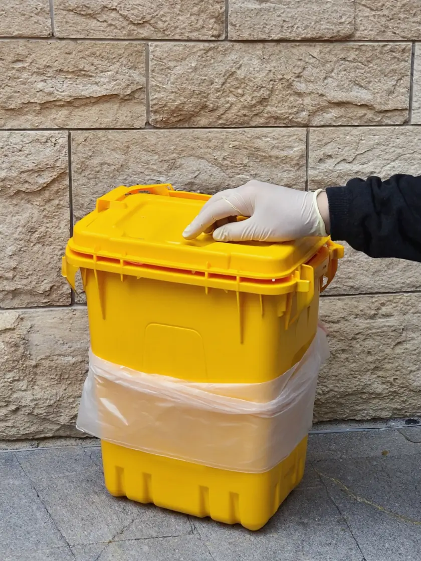 Sharps disposal bin sealed and labelled for collection